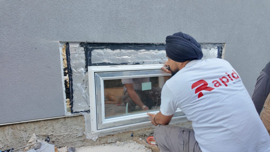 technician installting a basement window